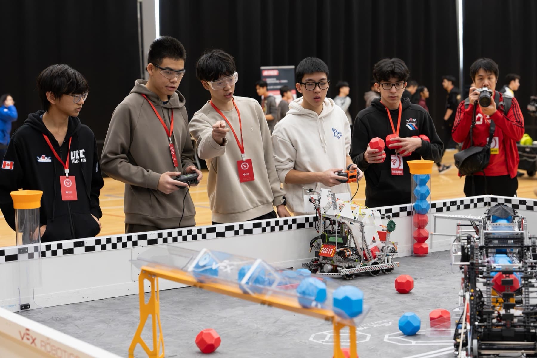 A drive team with controllers at the field during a match